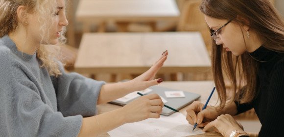 two ladies sitting, creating a skill development plan 