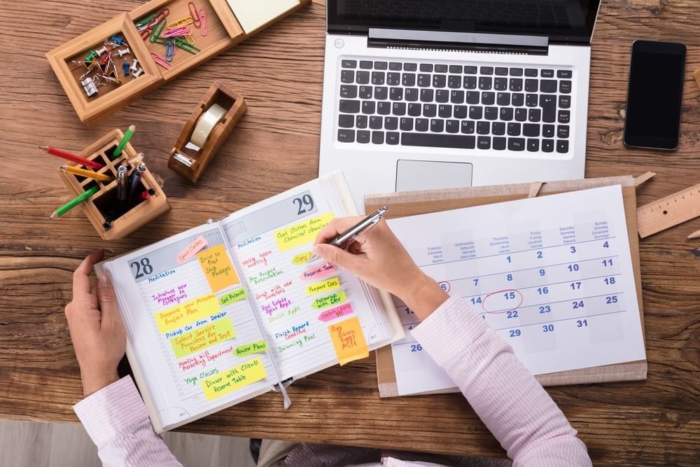 books, laptops, a person creating a study strategy plan